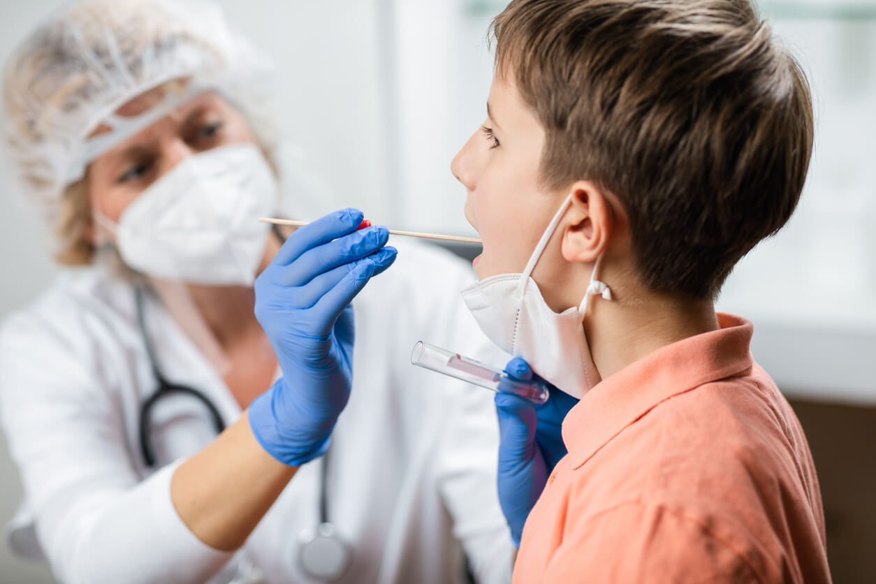 doctor examining adolescent male